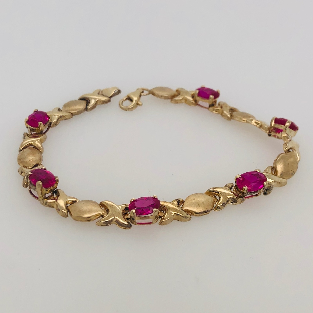 10K Yellow Gold   X   Link Oval Synthetic Ruby Bracelet 7.5 Inches