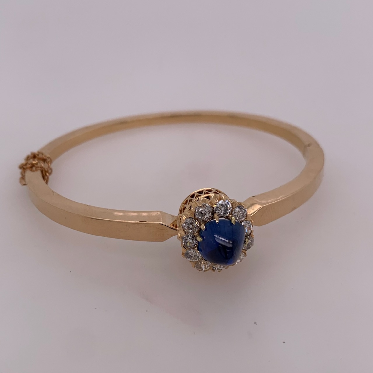 14k Rose Gold Bangle With 4.12CT Blue Un-Heated Cabochon Cut Blue Sapphire with Old Mine Cut Diamond Halo

Comes With Gemological Report