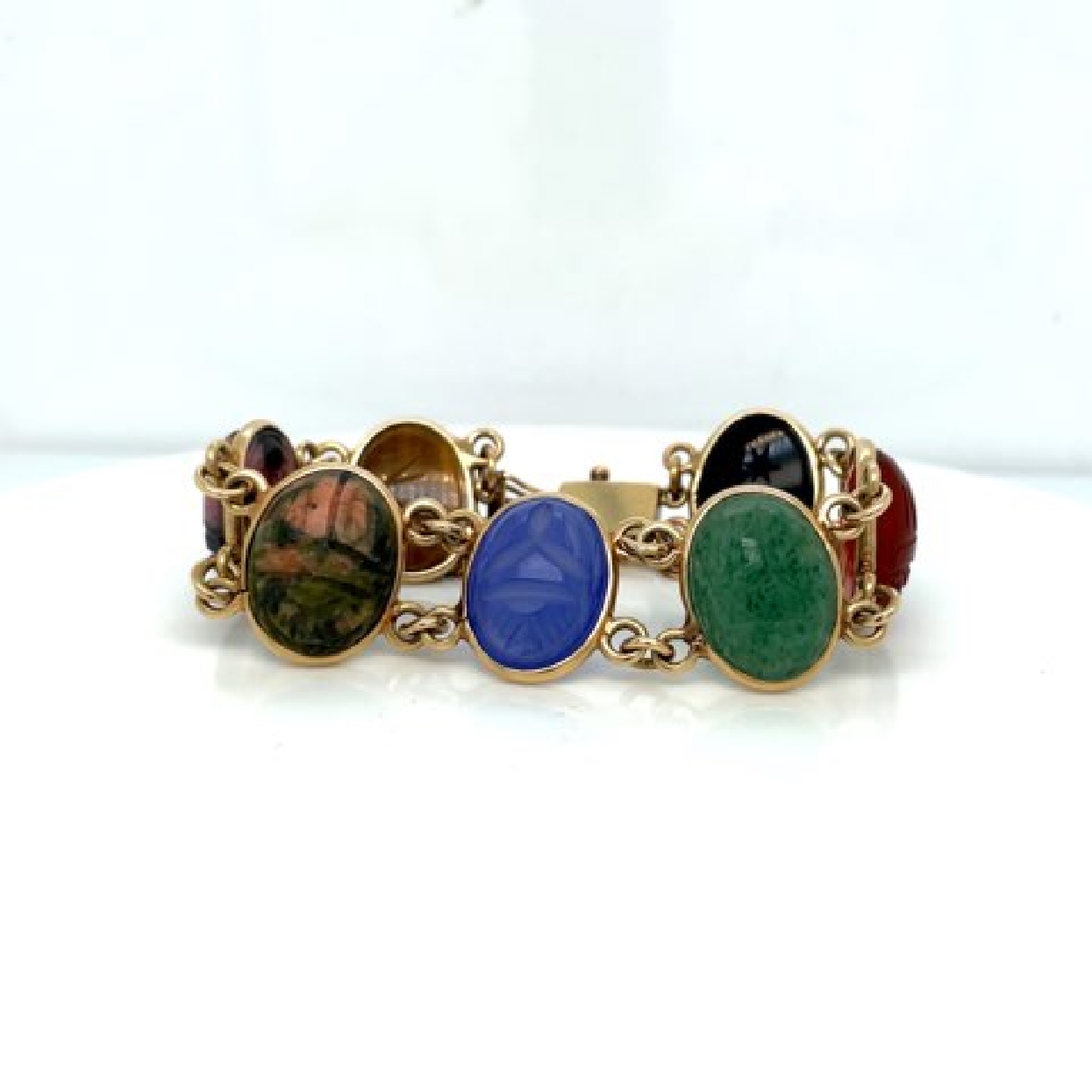 14K Yellow Gold Scarab Bracelet with Tigers Eye; Agate; Onyx; Carnelian; and Chalcedony

7 Inches