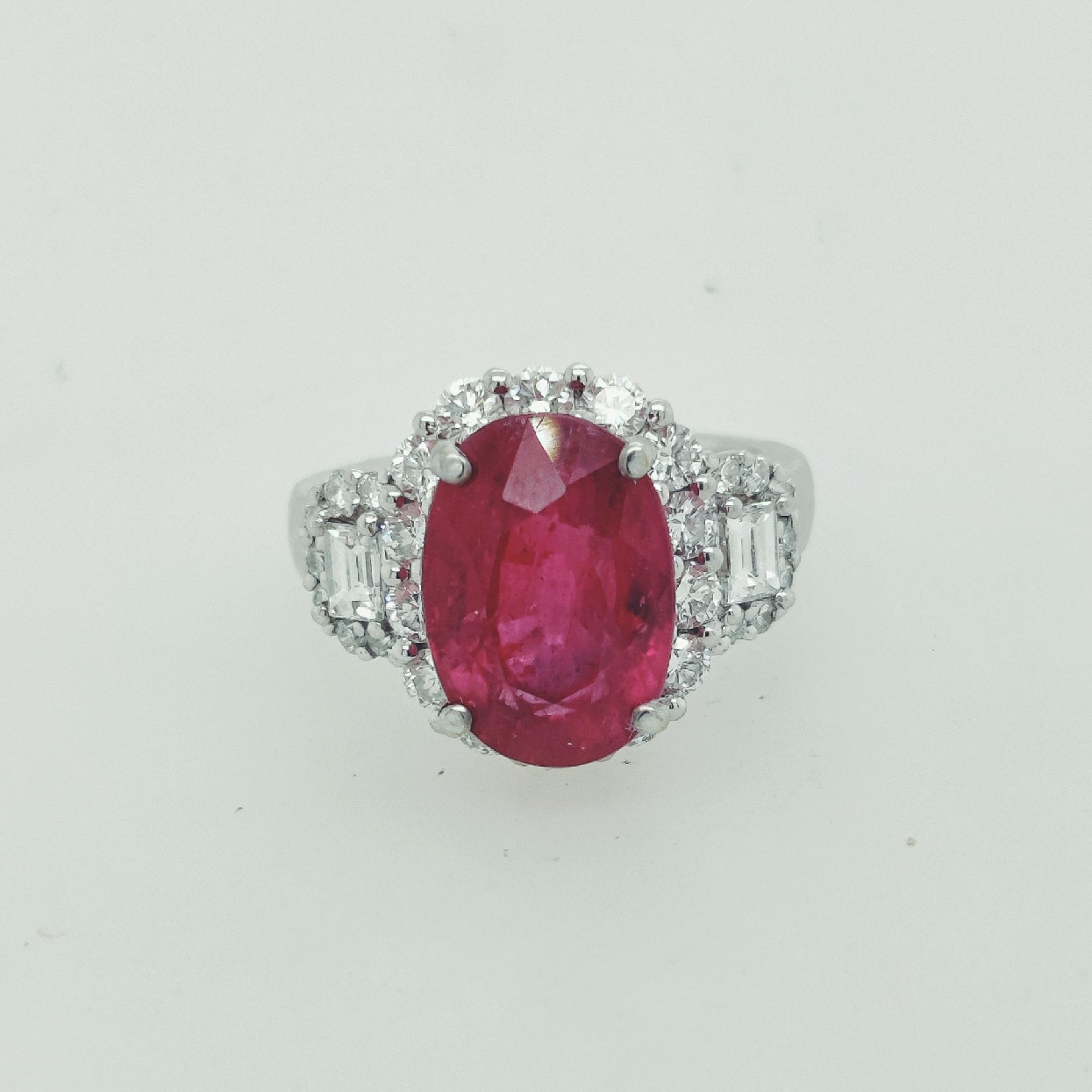 18K White Gold Ruby Ring with Diamond Halo; Size 6.5
6.21CT Ruby 
Diamonds are Approximately 1.18CTTW; VS color/F Clarity