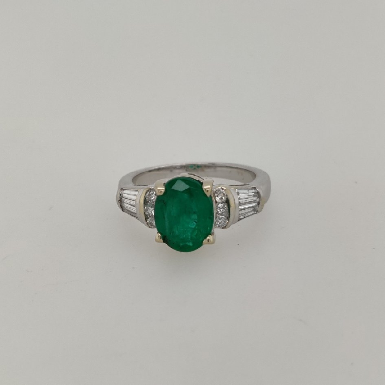 18k White Gold Emerald Ring with Round and Baguette Diamond Accents Size 6.75

Emerald is Approximately 2.40CT
Diamonds are Approximatel 0.50CTTW

6 Round Diamonds weigh Approximately 0.18CTTW
4 Baguettes weigh Approximately 0.32CTTW
