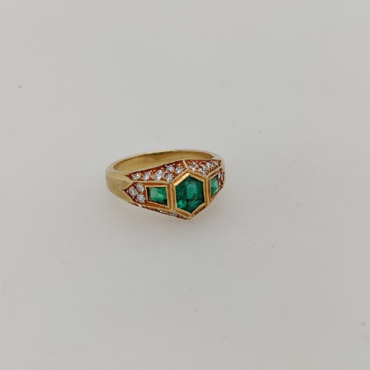 18K Yellow Gold Hexagonal Step Cut Emerald Ring with Trapezoid Emerald Accents and Pave Diamonds on the Shank; size 6.25