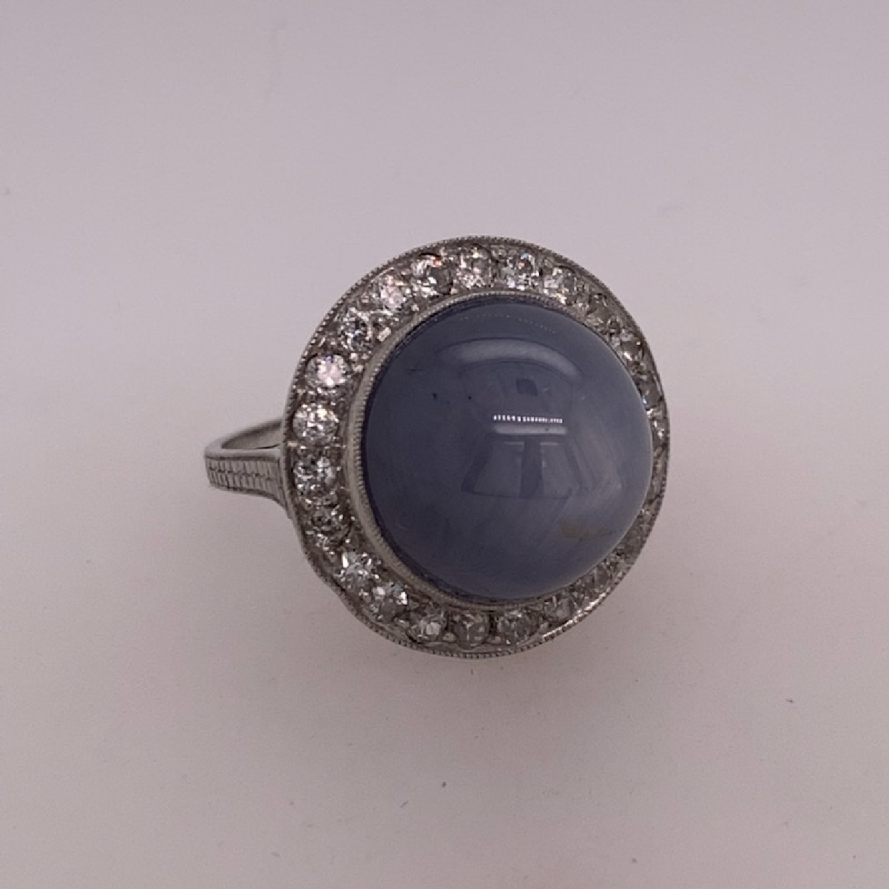 18k White Gold Un-Heated Grey-Blue Burma Star Sapphire with Old Mine Cut Diamond Halo Size 7

Comes with copy of AGL Certificate