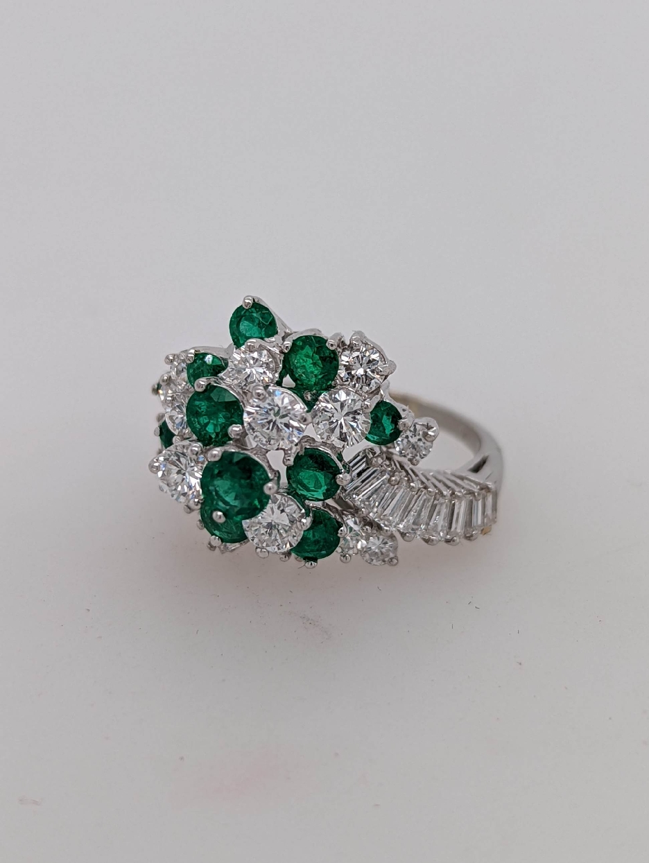 Platinum Bypass Style Emerald and Diamond Cluster Cocktail Ring with Diamond Baguettes on the Shank; Size 7.25

Diamonds Weigh Approximately 3 CTTW 