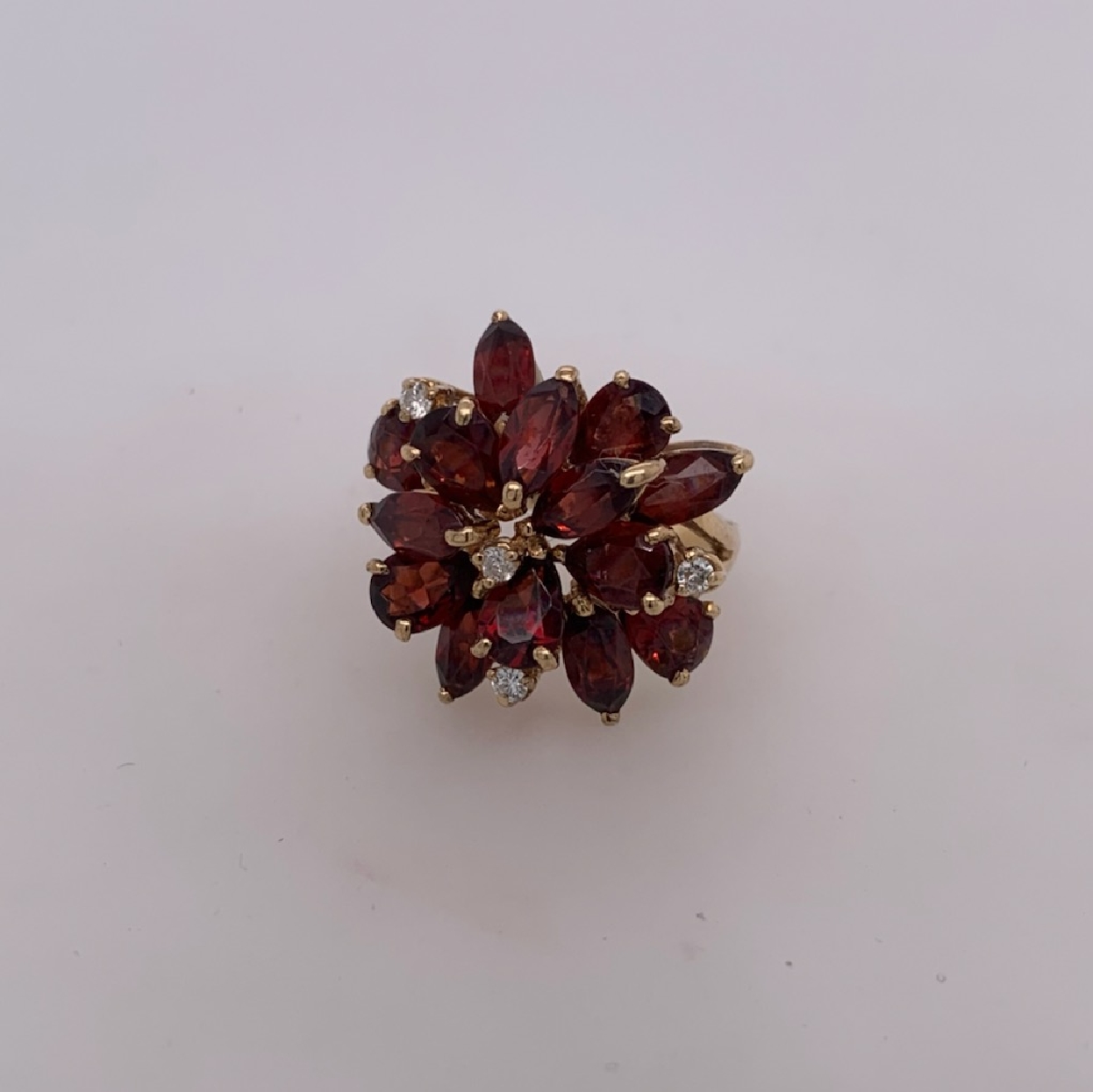 14K Yellow Gold Pear and Marquis Shaped Garnets in Floral Cluster with Small Diamond Accents

Size 6