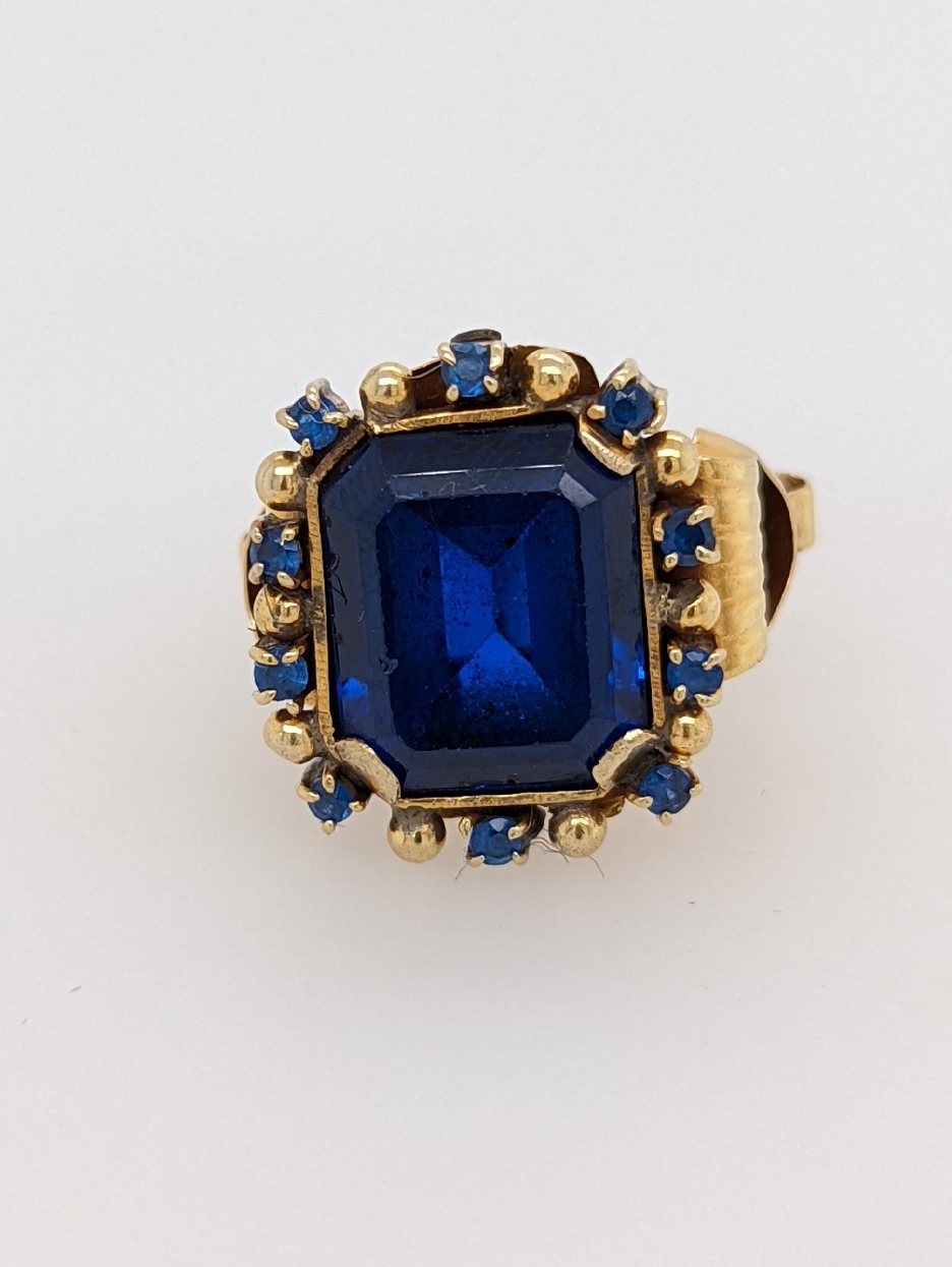 Vintage 18K Yellow Gold Emerald Cut Synthetic Sapphire Ring with Genuine Sapphire Halo and Column Detail on the Shank; Size 5.75