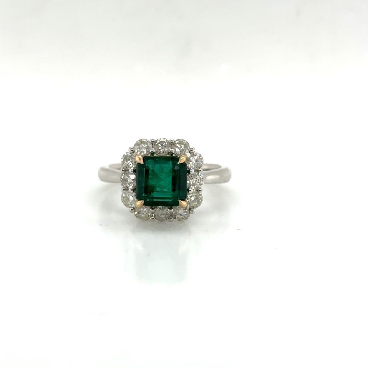 18K White and Yellow Gold Ring with a 2.2 ct Square Cut Emerald and .96 ct Diamond Halo 
Size 7