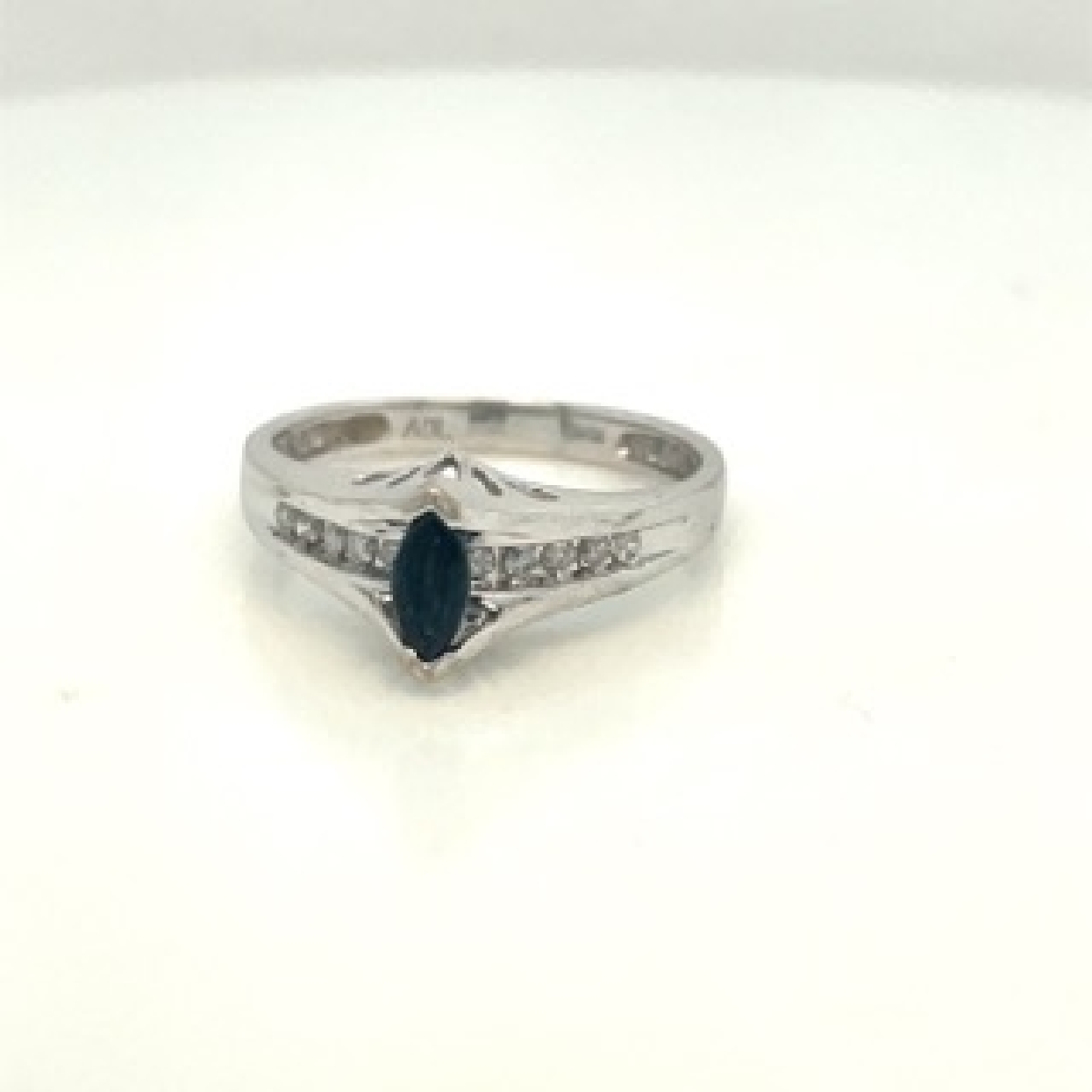 10K White Gold Ring with a Marquise Sapphire Center and Channel Set Diamond Accent
Size:7