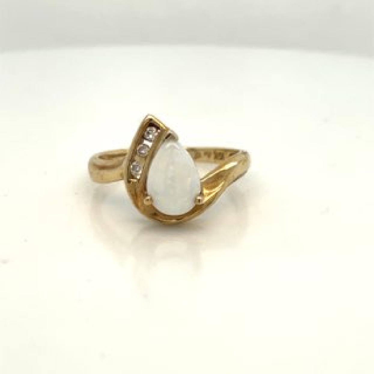 10K Yellow Gold Ring with Pear Shaped Opal and Three Diamonds Accent .06 ct
