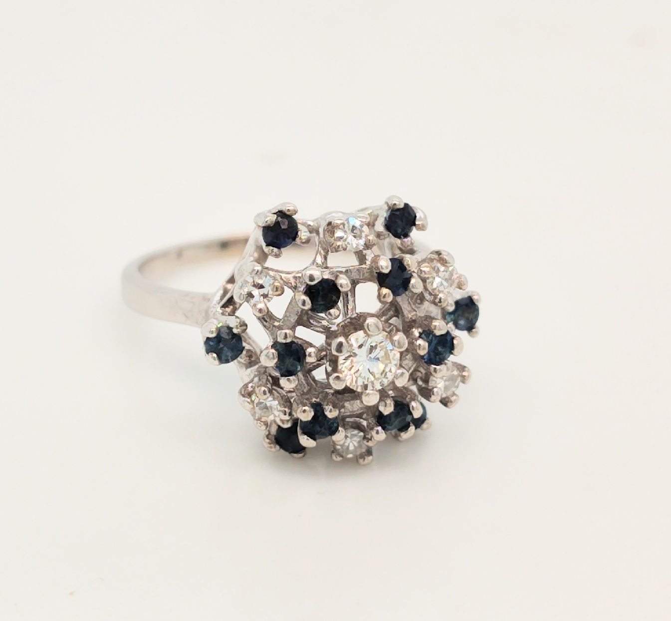 14K White Gold Sapphire and Diamond Ring Containing 12 Sapphires and 7 diamonds graded SI/K Size 5.5