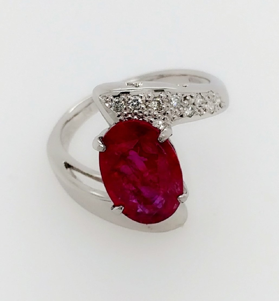 platinum diamond setting with an oval ruby at 2.17 ct
size 6