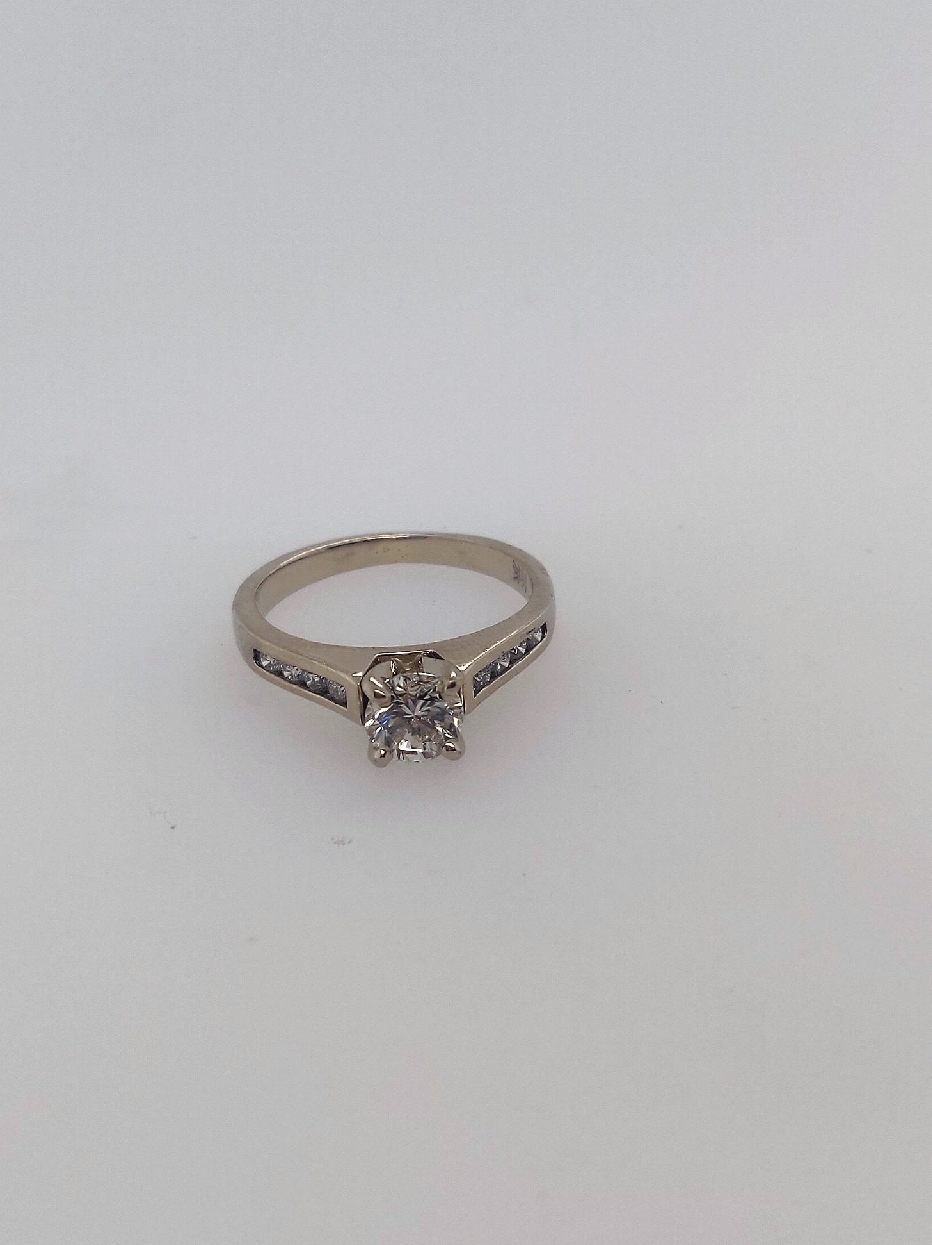 14k white gold diamond ring w/approx .50ct four prong set center rbc SI2/I and 8 channel set rbc side diamonds approx 0.16 ctw sides H-I. Size 5. 