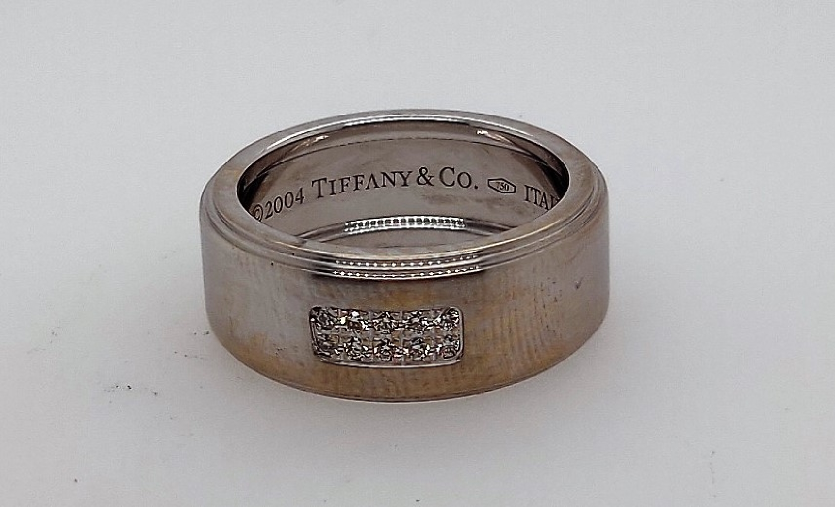 Tiffany and Co 
18kt white gold band with diamonds
0.10CTTW~
size 6.25