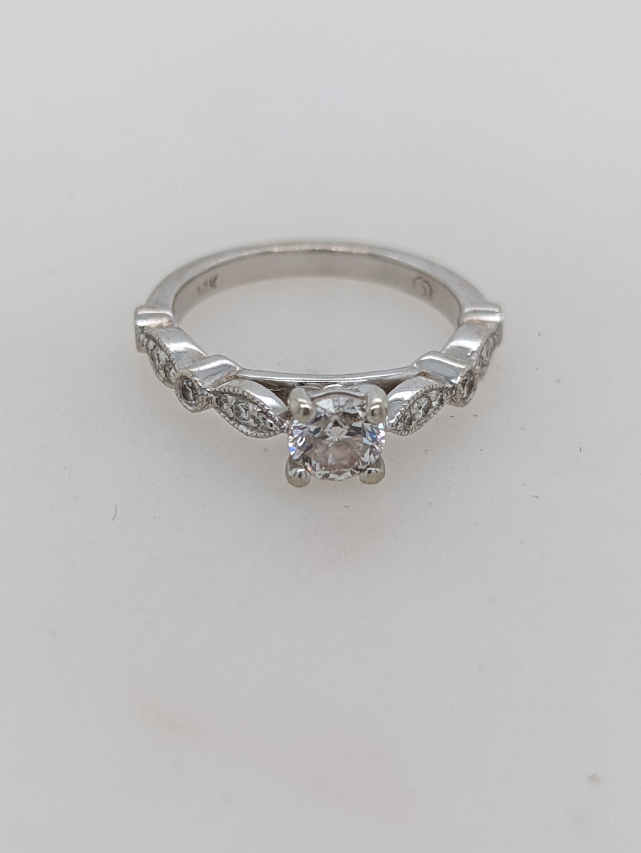 14K White Gold Engagement Ring With 0.50CT Center Stone and Diamonds on the Shank; Weighing Approximately 0.16CTTW
Size 5

Center Stone is F Color; SI1 Clarity
Accents are G-H Color; SI Clarity

Appraisal on File