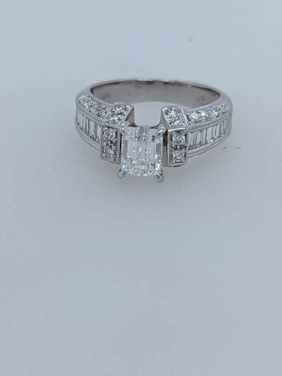 14K White Gold Engagement Ring with Emerald Cut Center Stone and Round and Baguette Accents; Size 5.5

Center Stone is 1.03CT; E Color; SI1 Clarity