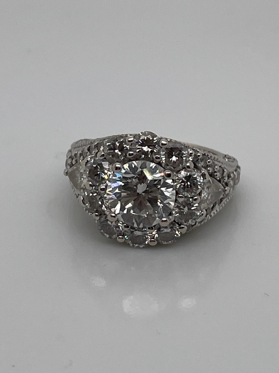 Custom 14K White Gold Halo Engagement Ring. 
1.88CT. Round G SI2 Diamond
Two Trillian F-G VS2-SI1 diamonds totaling 0.4CT
1.7CT Total Diamond Melee F-G VS2-SI2

Apx 4cttw Diamonds
Size 5