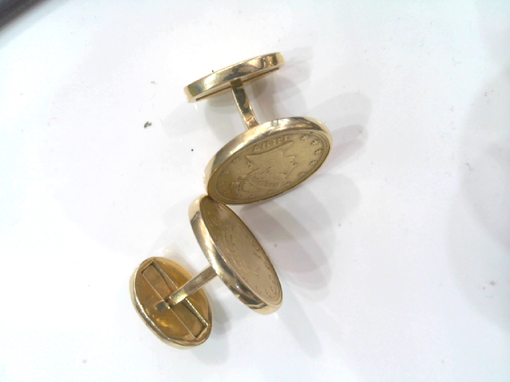 one pair of gold cufflinks with 1897 5 Dollar gold coins in a 14kt frame.