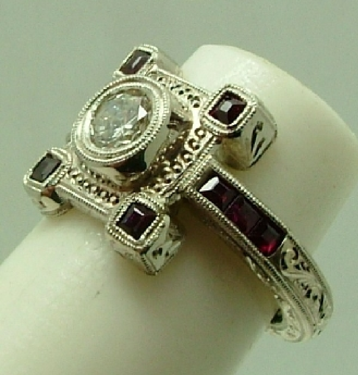 14K white gold hand engraved ring with rubies and diamond.