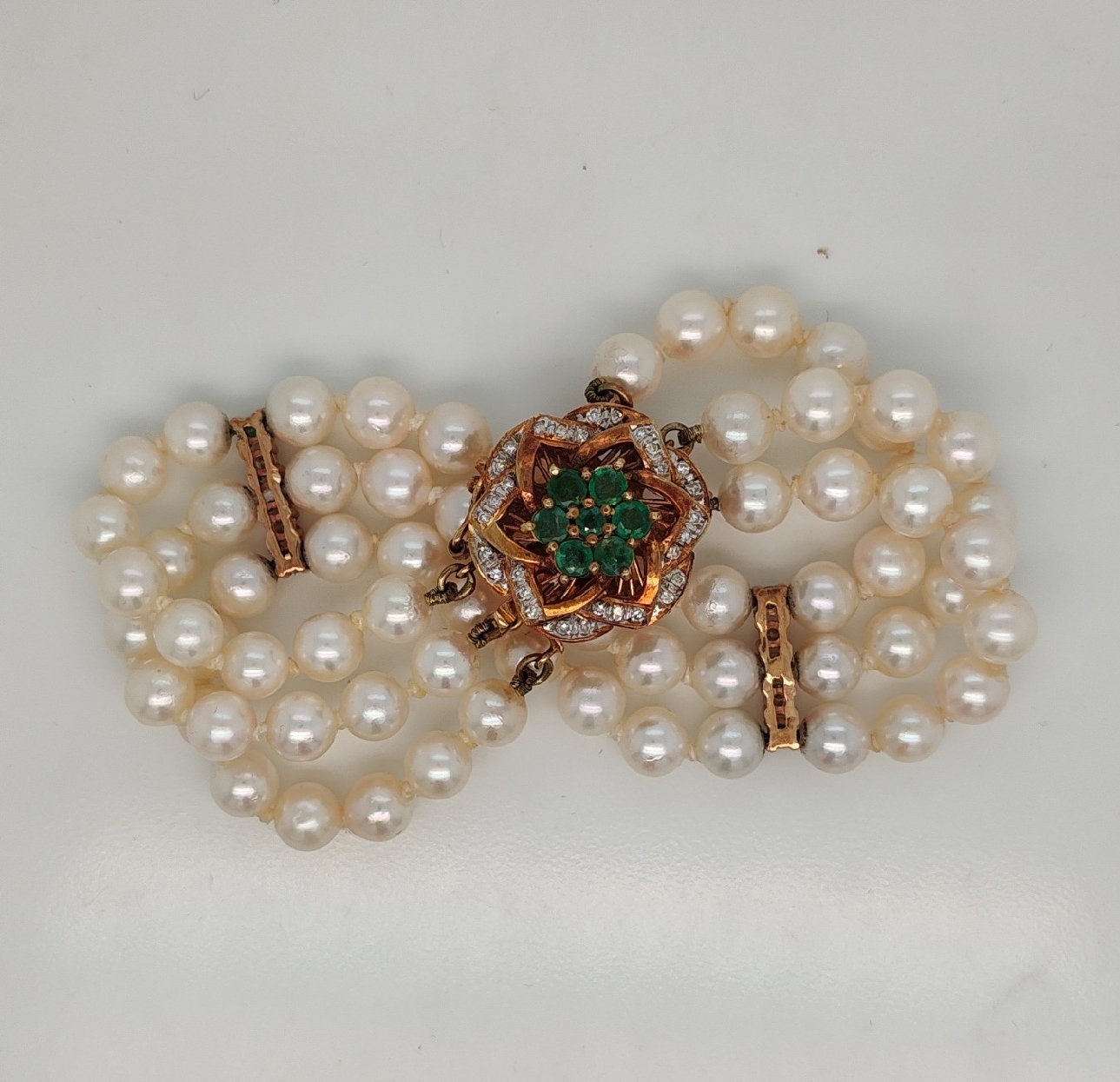 Triple Strand Pearl Bracelet with 14K Yellow Gold Emerald and Diamond Floral Clasp 