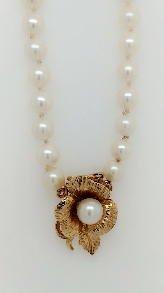 31   Strand Akoya 6.25-6.5mm pearls with 14kt flower clasp.