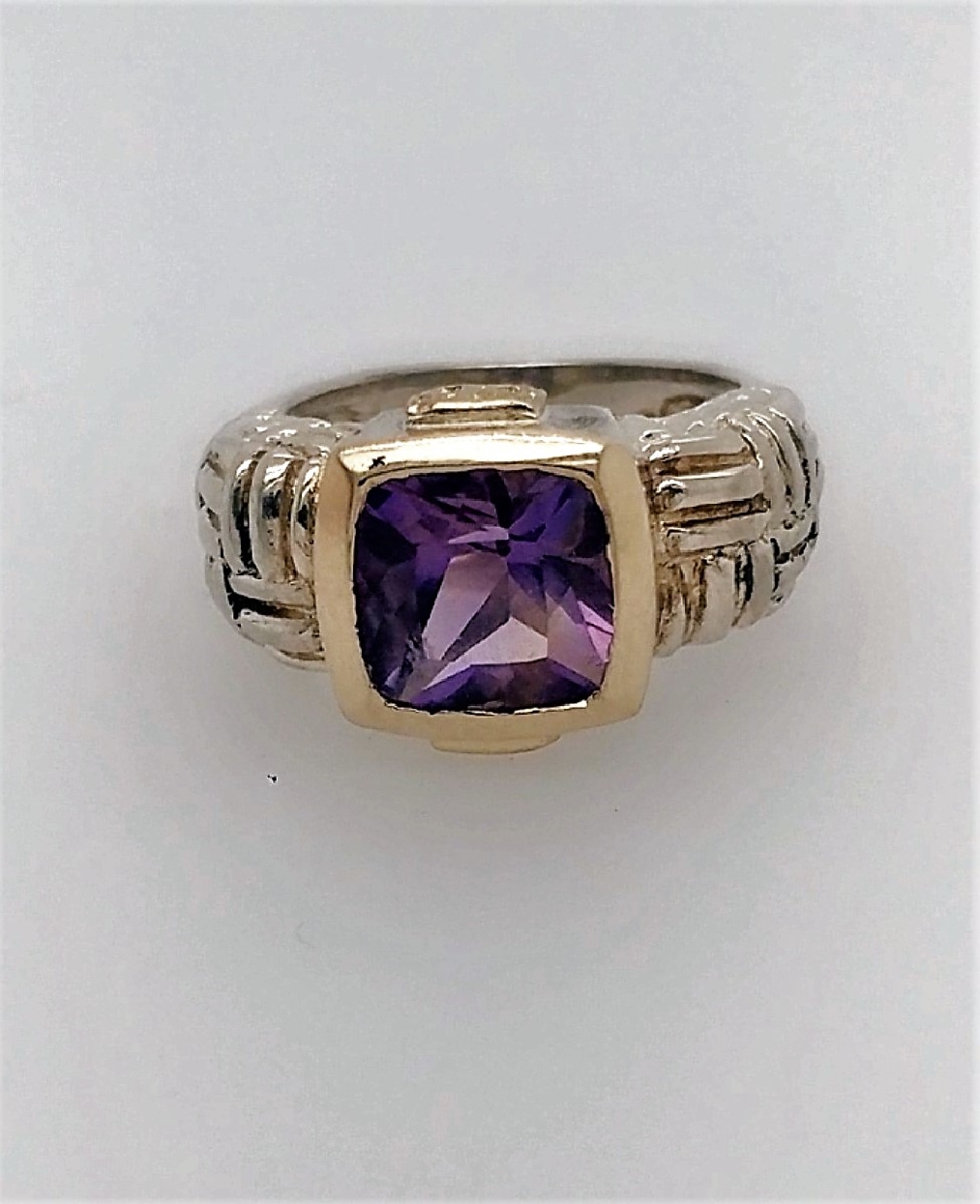 Sterling silver and 14k yellow gold bezel set amethyst ring. Size 6.25.