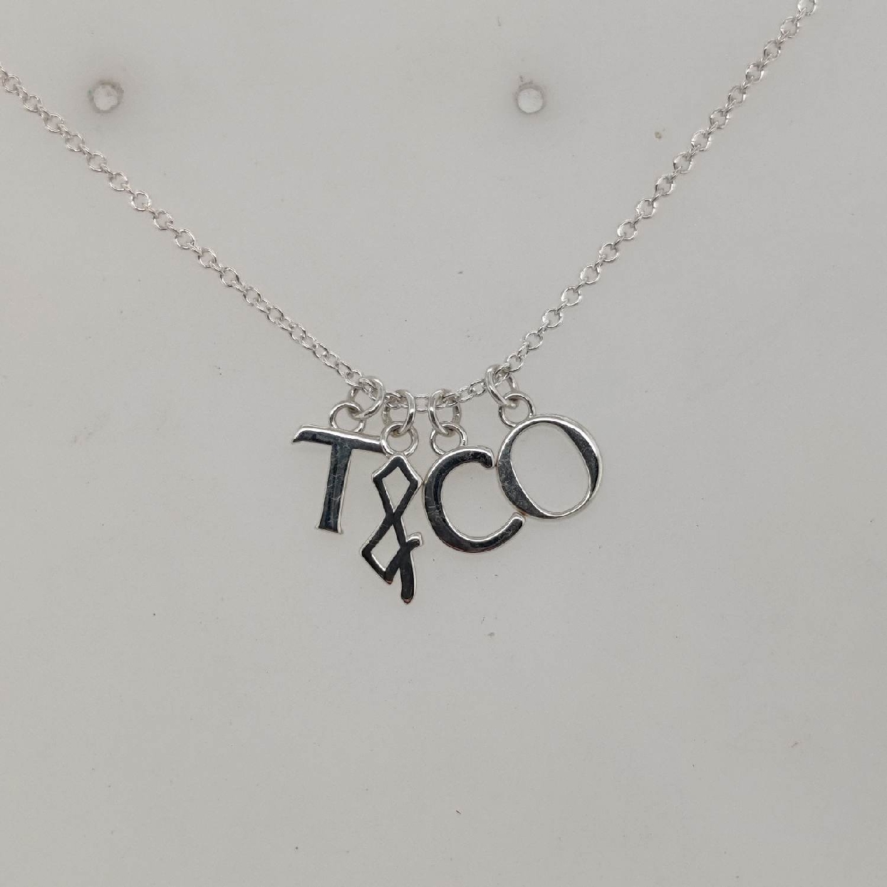 Sterling Silver Tiffany & Co. Charm Necklace; 18-20 inch

Comes with Box and Pouch