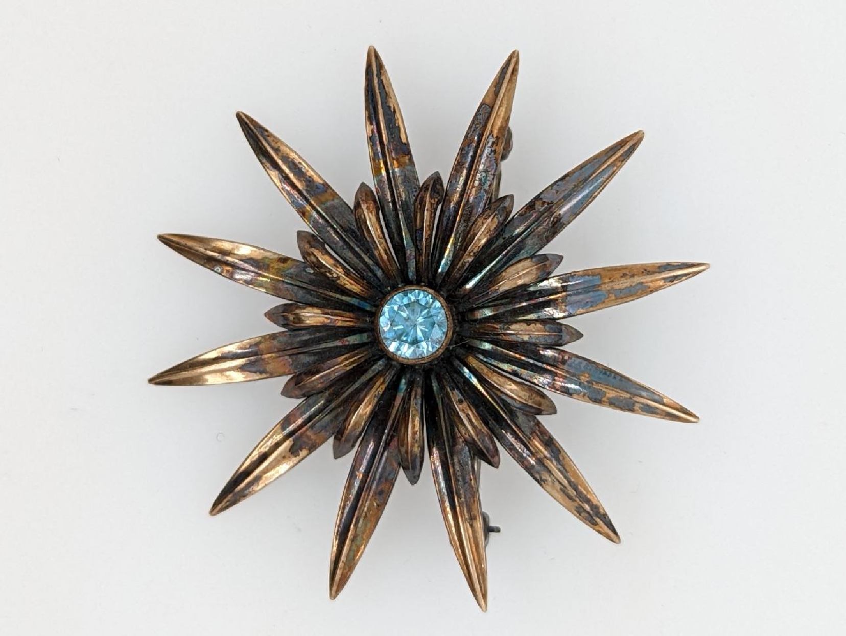 Vintage Symmetallic Sterling Floral Pin with 14K Gold Plating and Blue Topaz Colored Paste Stone