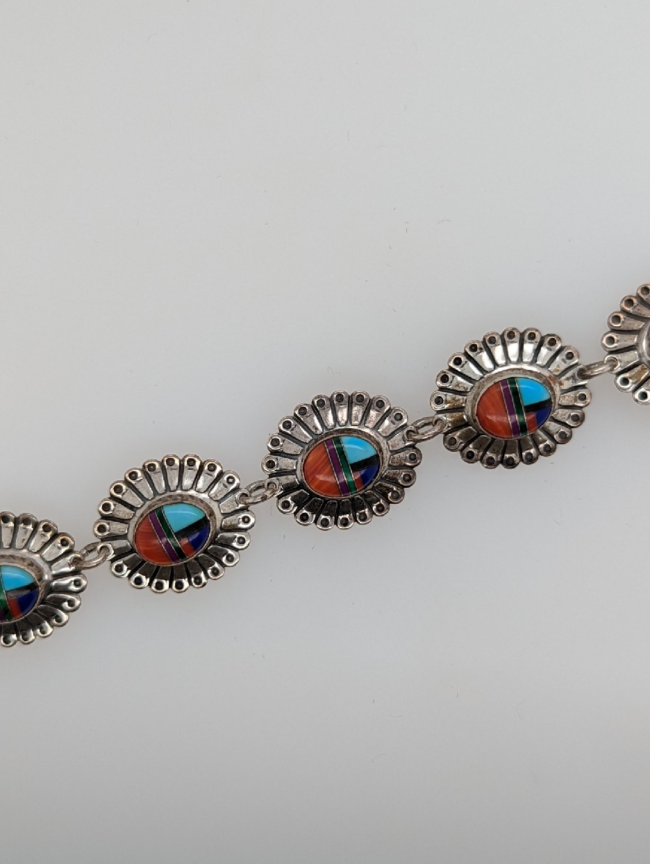 Zuni Sterling Silver Concho Link Bracelet with Coral; Spiny Oyster; Onyx; Malachite; Lapis; and Turquoise; 7.5 inches
Signed QT