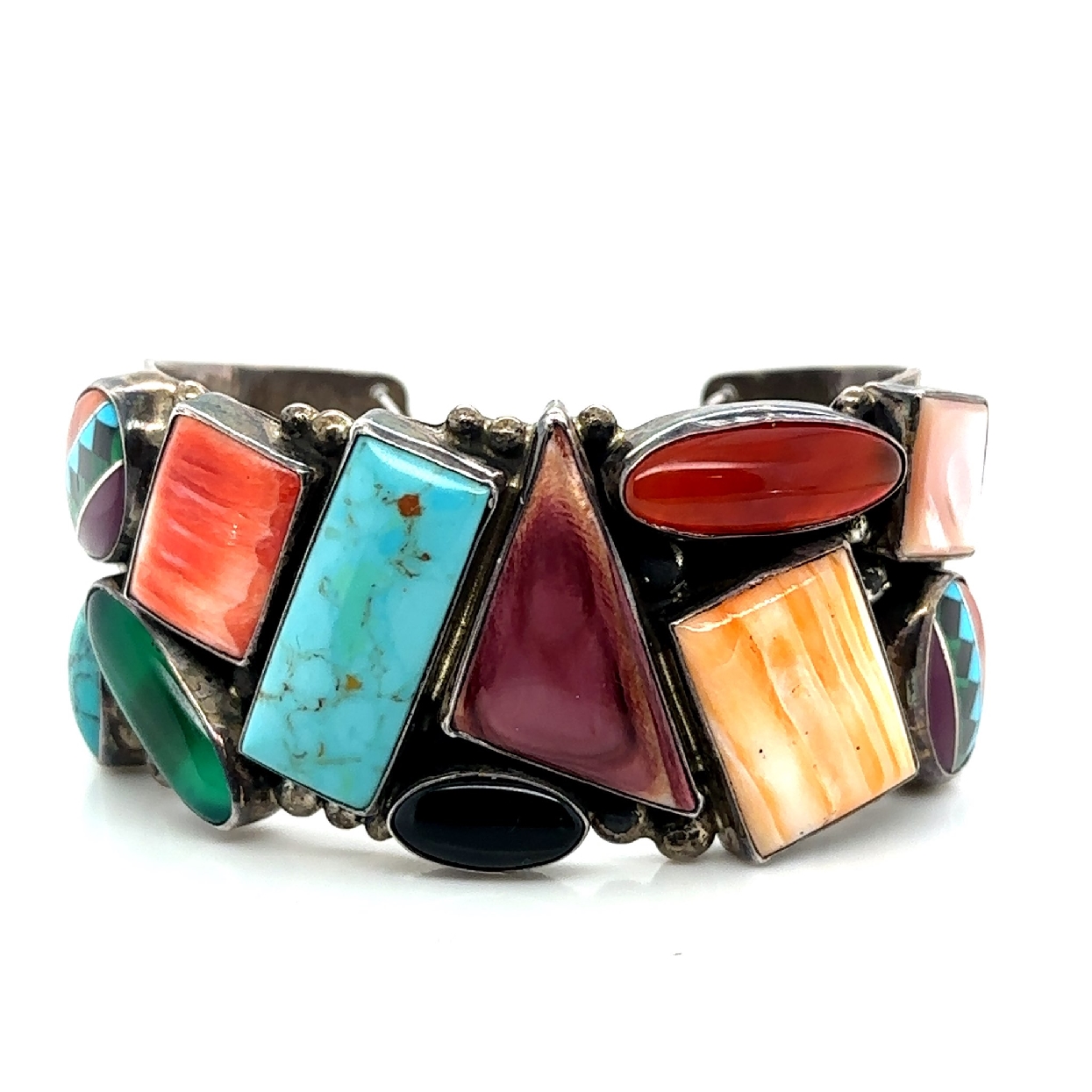 Native American Cuff with an assortment of stones including turquoise; coral; mother of pearl; malachite; carnelian; onyx; and green onyx