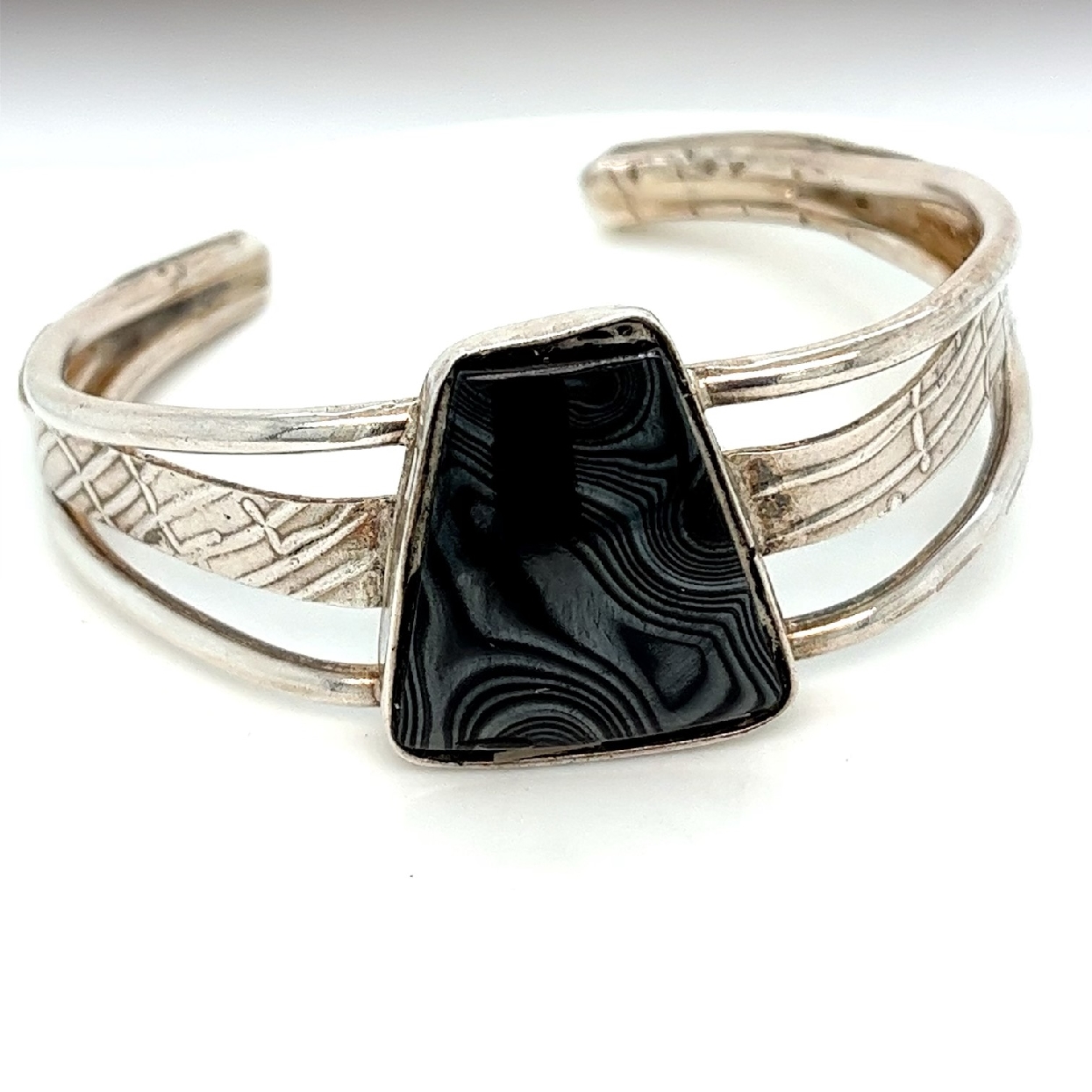 Sterling Silver Cuff with Bezel Set Black Trapezoid Stone and Stamped Pattern on Middle Band of Cuff 