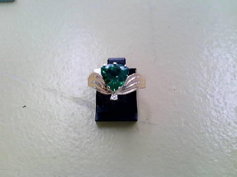 1120: One ladies 10k yellow gold Trillion Lab grown Emerald stone of 1.53crtw.  and one round brilliant cut diamond  ring