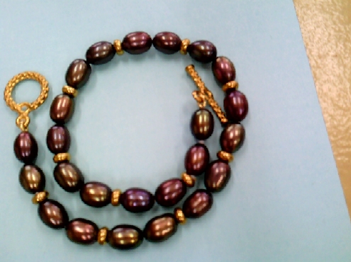 1603: One ladies Brown Freshwater Rice pearl bracelet with gold tone beads and toggle clasp