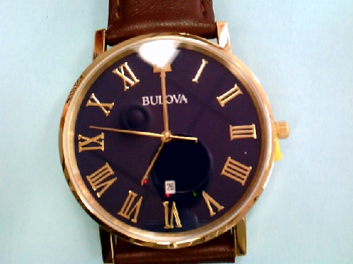 1800: One Bulova gents brown leather strap yellow tone blue dial roman numbers calendar watch 