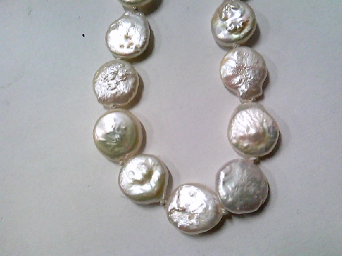 2000: One 7 inch long round disc shaped Freshwater white pearl bracelet.