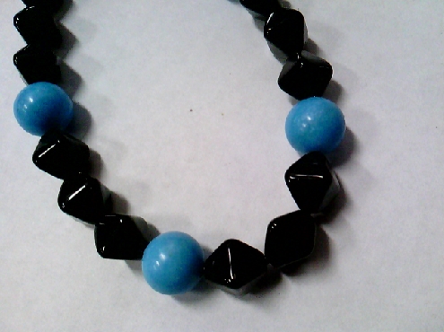 2461: Oen custom made black triangular shaped beads with round blue beads stretch bracelet