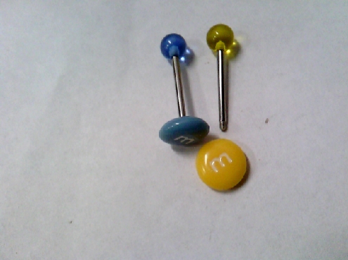 2467: One Hollywood Body jewellery industrial bar with yellow or blue ends with letter M