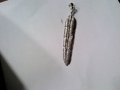 2925: One sterling silver long Feather charm with a small Bird on back 