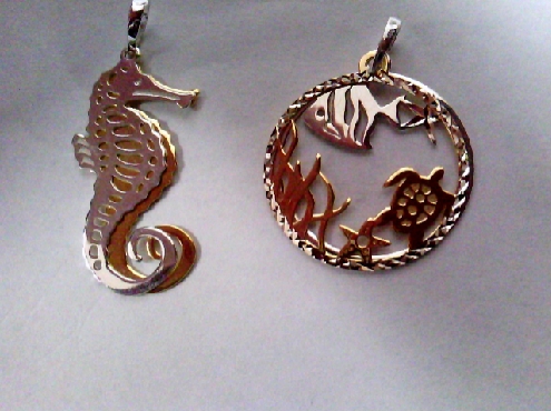 2946: One sterling siliver and yellow gold plated Sea life motif doubl charm 
seahorse/ sea scene