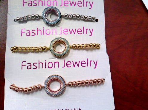 3689: One costume jewellery stretch bracelet of rose/yellow or siliver tone beadeds with crystal  circle trim in middle