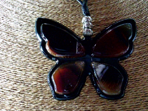 3691: One Model France costum jewellery necklace of a brown Acrylic brown Butterfly on a double strand leather strap