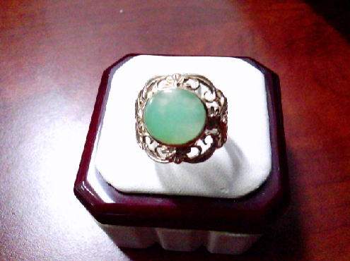 3837: One custom made 10k yellow gold floral motif ring set with a hand cut and polished Jade stone 