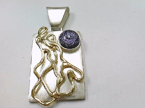 384: one custom made rectangular pendant with 14k yellow gold plated designed wire pinned on front. Set with one round purple diamond Inclusion tm dichoric glass stone