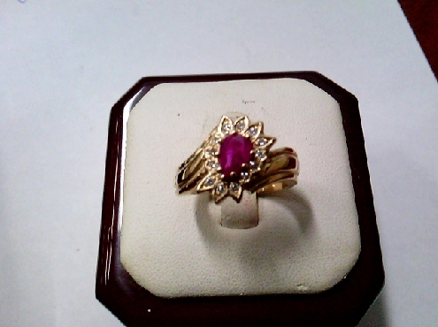 3854: one ladies custom made 14k yellow gold pear shaped genuine Ruby and diamond cluster ring 
0.78crtw ruby 
0.13crtw diamonds