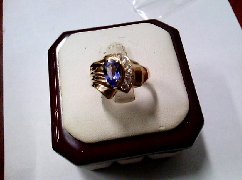 3855: One custom made 10k yellow gold fashion ring  set with one pear shaped genuine Tanzanite of 0.56crtw and  7 RBC diamonds of 0.28crtw VS-SI GH