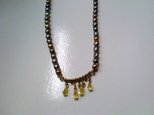 3878: One strand of Freshwater Potatoe shaped grey pearls with a middle bar with 4 yellow crystal drops 