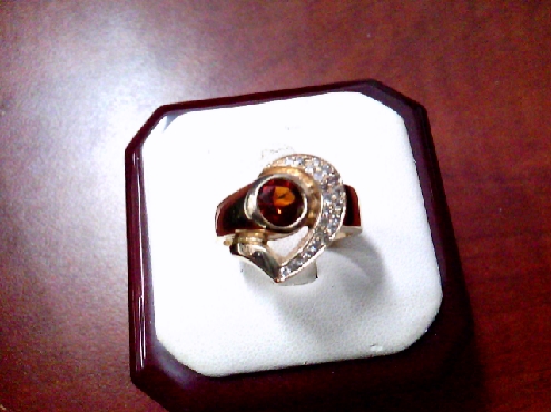 3940: One ladies 10k yellow gold custom made Diamond and Madeira Citrine ring .

0.69crtw Maderia
22 RBC 0.22crtw SI1-I1 HI