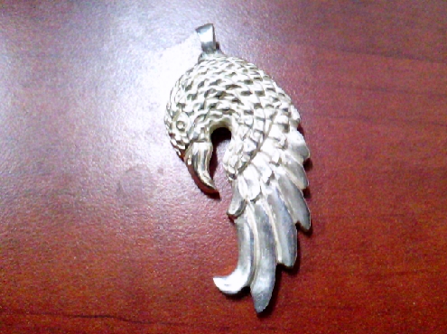 3950: One custom made 925 sterling silver eagle and feather style pendant