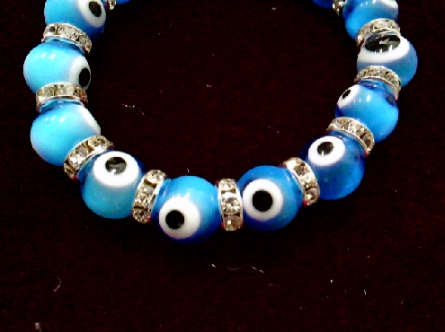 4192: One Glass bead Evil Eye Aqua colored stretch bracelet