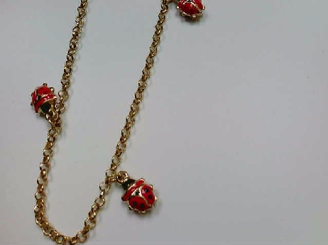 53169GJBR: one ladies 10k yellow 4 small red/black Lady Bug charm bracelet on a rolo style chain