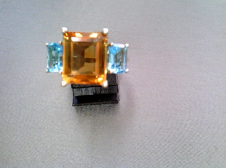 709: one ladies 10k white gold ring set with  Emerald cut genuine Citrine stone and two emerald cut genuine Blue topazes